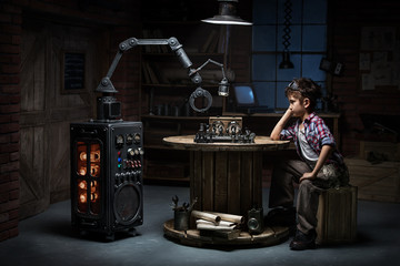 Boy with a robot helper playing chess