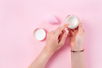 Woman hands with cream box