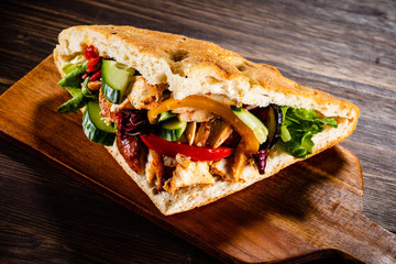 Kebab - grilled meat and vegetables on wooden background