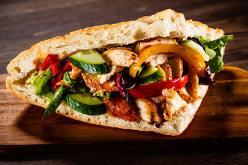 Kebab - grilled meat and vegetables on wooden background