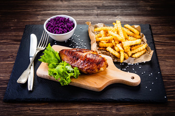 Grilled chicken breast, French fries and vegetables