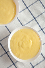 Homemade vanilla custard pudding on cloth, overhead view. From above, flat lay. Closeup.