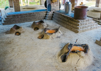 Clay ovens on the floor for cooking. Vedic school Gurukul for boys. Mayapur, India