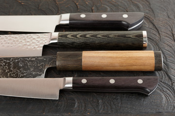 Knife handles on black cutting board