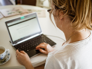 Fototapeta premium Middle-aged woman using laptop at home