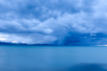 Cumulonimbus storm raining in the Namtso ( or Lake Nam; Nam Co), which is a mountain lake in...