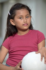 Serious Child Female Athlete With Volleyball