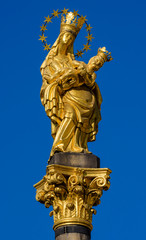 Fototapeta na wymiar a golden statue of Madonna with a baby, Plague Column, Pilsen, Czech Republic