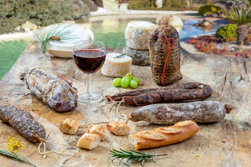 Corsican specialities appetizer: delicatessen, and cheese made in Corsica over a swimming pool...