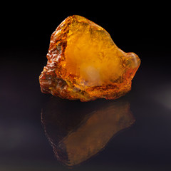 A unique piece of solar amber on a black background.