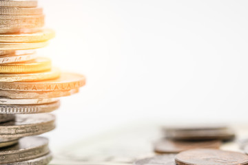 Closeup of gold and silver coins stacking in each different position on white background - Image.