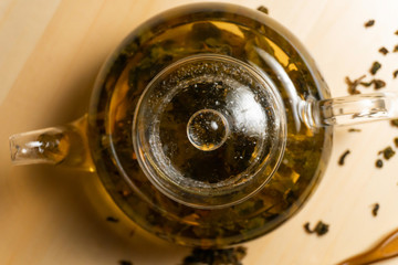 Top view on teapot with brewed chinese green tea