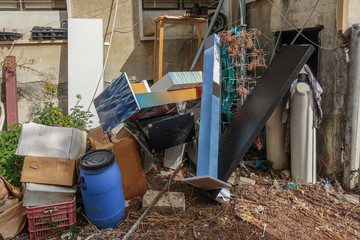 Large collection of junk and rubbish thrown into a corner.