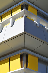 corner of a building with yellow sun blinds