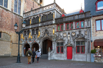 Front of an old house with tourists in the historic centre of Bruges
