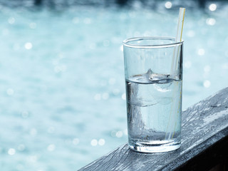 closeup glass of iced water with straw