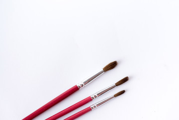 Fototapeta premium close up of paint brushes isolated on white background. table for paint. text