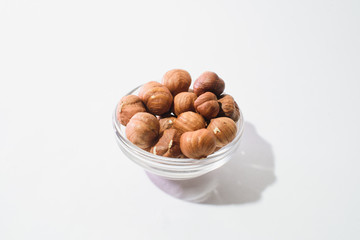 Obraz na płótnie Canvas The top view of hazelnuts isolated on white background
