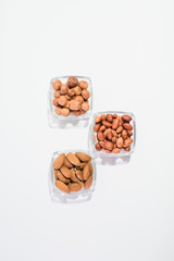 Peanuts, hazelnuts and almonds on a white background