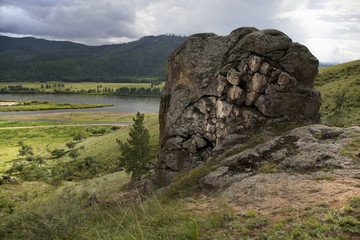 Fototapeta premium Summer landscape. Zabaykalsky krai, a village Zhindo, Far East, Russia. Chikoi river on the border of Russia and Mongolia. Siberia. Hills. Siberian river. Summer in Siberia. village on river