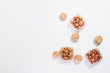 Peanuts, hazelnuts, almonds and walnuts on a white background