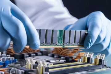 The scientist holds the computer part