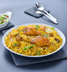 Chicken Biryani, a yummy & fluffy rice dish with spicy savory chicken pieces with salad.