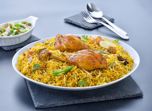 Chicken Biryani, a yummy & fluffy rice dish with spicy savory chicken pieces with salad.