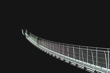 .suspension bridge engulfed in the dark to represent the unknown