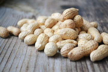Peanuts in shells on a wooden table