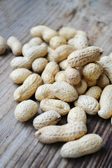 Peanuts in shells on a wooden table