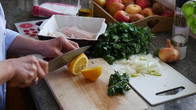 preparation of fresh fish, raw cod fillets with addition of herbs and lemon