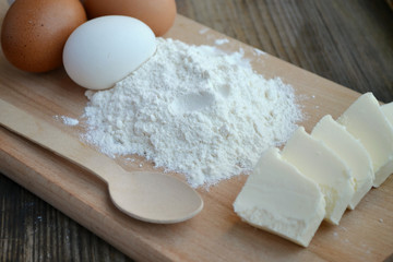 White flour with eggs on a cooking board