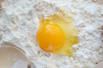 White flour with eggs on a cooking board
