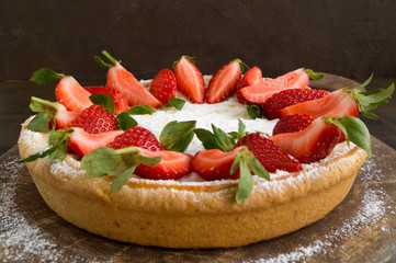cheesecake with strawberries on a wooden Board.