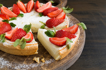 cheesecake with strawberries on a wooden Board.