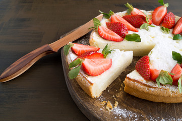 cheesecake with strawberries on a wooden Board.