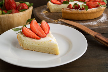 cheesecake with strawberries on a wooden Board.