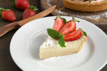 cheesecake with strawberries on a wooden Board.