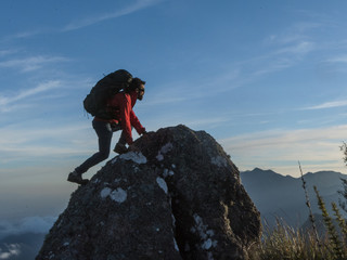 man climbing mountains landscape