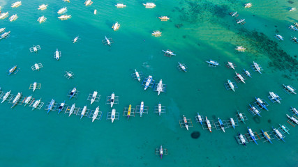 Fototapeta na wymiar Aerial shot of local boats in El Nido Beach, Palawan, Philippines