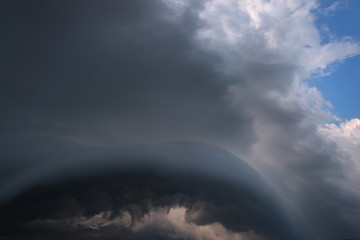 Scary epic sky with menacing clouds. Hurricane wind with a thunderstorm. Stock background, photo