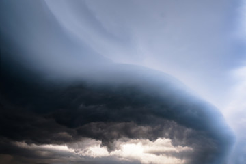 Scary epic sky with menacing clouds. Hurricane wind with a thunderstorm. Stock background, photo