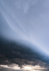 Scary epic sky with menacing clouds. Hurricane wind with a thunderstorm. Stock background, photo