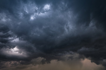 Naklejka na ściany i meble Scary epic sky with menacing clouds. Hurricane wind with a thunderstorm. Stock background, photo
