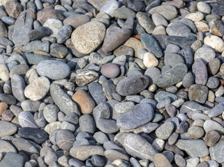 Stone pebbles on the seashore as an abstract background