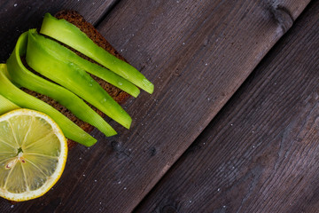 sandwiches with avocado on wooden background, copyspace