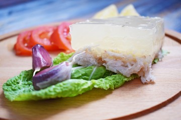 Aspic of chicken and vegetables on wooden background.