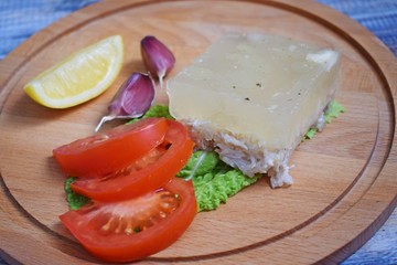 Aspic of chicken and vegetables on wooden background.