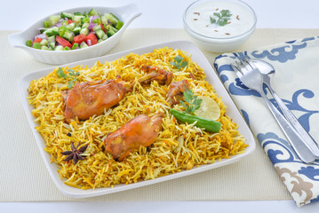 Chicken Biryani, a yummy & fluffy rice dish with spicy savory chicken pieces with salad.